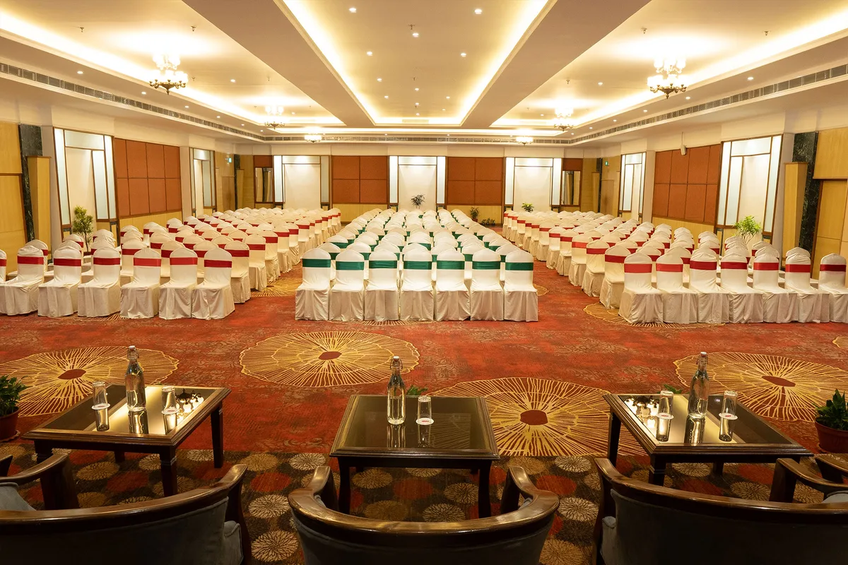 Event hall with rows of covered chairs at Pokhara Grande
